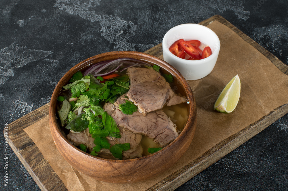 Vietnamese fresh rice noodle soup with beef, herbs and chili. Asian cuisine