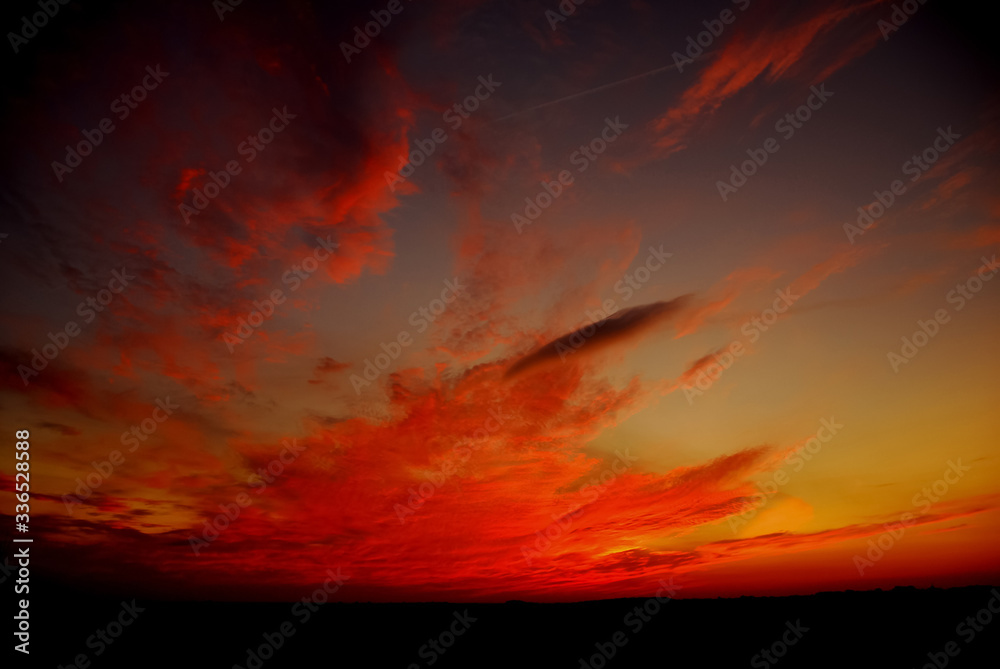 Fototapeta premium Beautiful red sky clouds at sunset wallpaper.