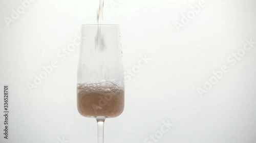 pours champagne into a glass close-up