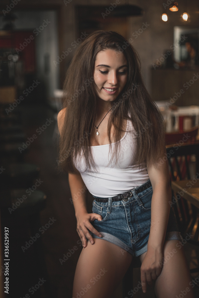 Beautiful woman posing for the camera sitting in a cafe. Beautiful woman posing for the camera sitting in a cafe.