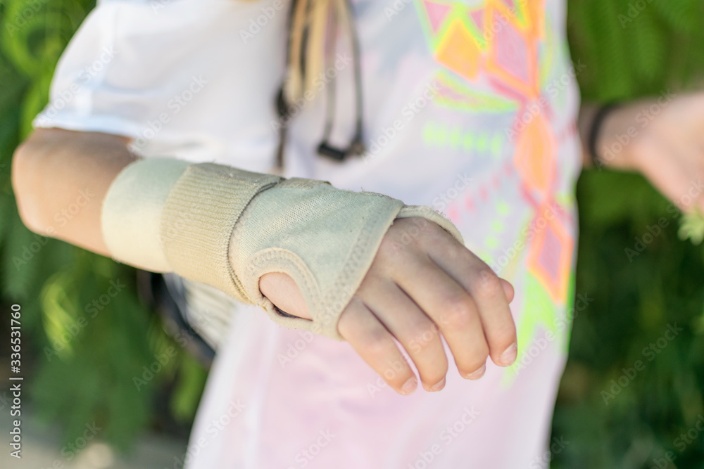Bandage on the girl's hand. Recovery after a fracture of the hand. Bandage on the girl's hand. Recovery after a fracture of the hand.