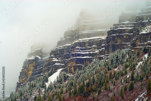 Sides of rocky mountains in a cloud