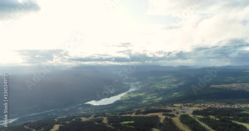 Spectalurar aerial view from the top of the hill of Oyer valley and Losna lake during peaceful cloudy day. photo