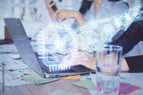 Double exposure of woman hands working on computer and data theme hologram drawing. Tech concept.