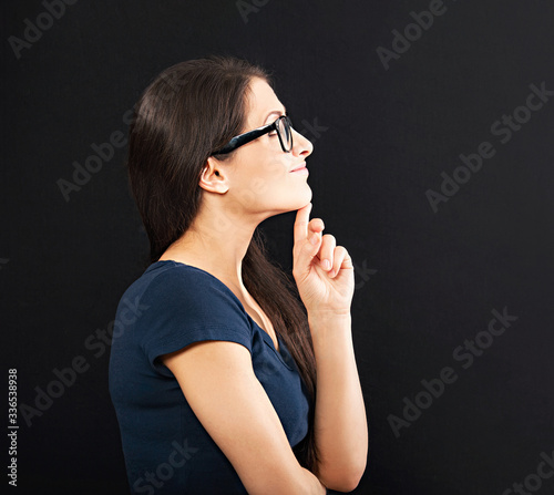 Happy woman in glasses holding the hand under the face and find the solution on problem situation. Corona virus. Studio portrait