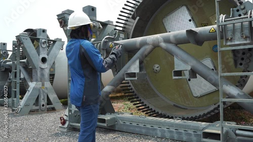 Woman engineer with hard hat against wind turbine footage 4K