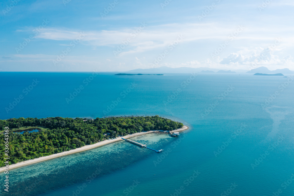 Aerial scenery view of picturesque island with crystal azure water and green vegetation.Bird's eye view of paradise beach shoreline, beautiful touristic destination for summer vacations,