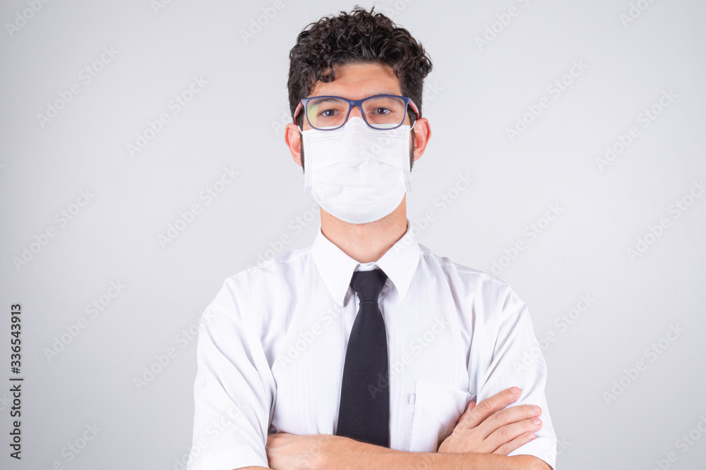 Man with mask on gray background. Protection against covid-19 during a pandemic. Man with mask on gray background. Protection against covid-19 during a pandemic.