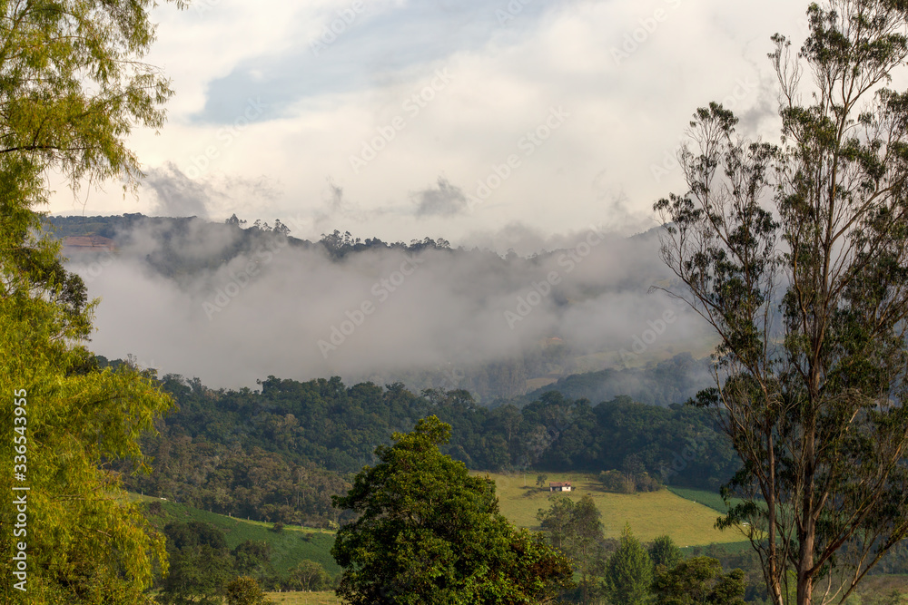 Early in the morning low clouds cover with mist the central Andean mountains in the department of Boyaca in Colombia Early in the morning low clouds cover with mist the central Andean mountains in the department of Boyaca in Colombia