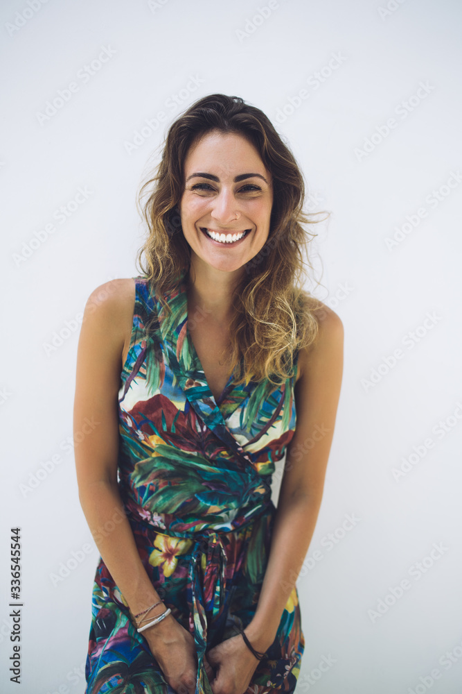 Charming smiling hispanic woman leaning on white wall Charming smiling hispanic woman leaning on white wall