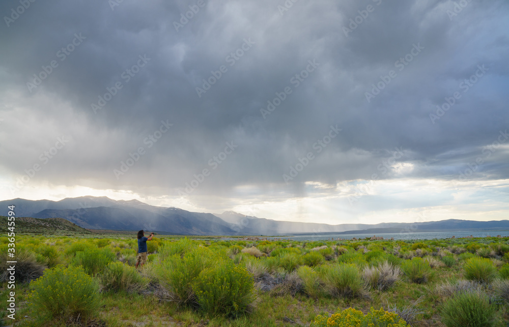 Man using Cell phone to take landscape photography