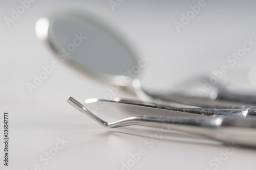 Dentist tools: mirror, dental probe and tweezers