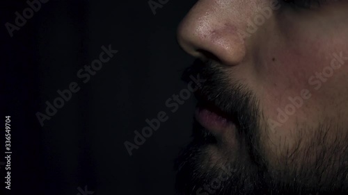 Close up shot of a patient with asthma using his inhaler to breath easily