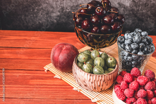 Melon on wooden table with black background