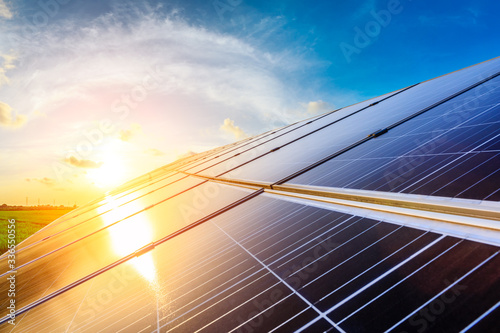 Photovoltaic solar panels on sunset sky background,green clean energy concept. photo
