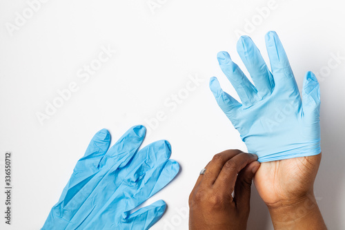 Black Man Putting on Protective Gloves