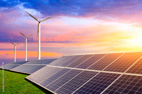 Solar panels with wind turbines in the setting sun,green energy.