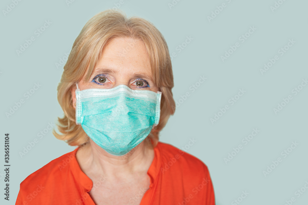 Older woman with face mask looking directly in camera Older woman with face mask looking directly in camera