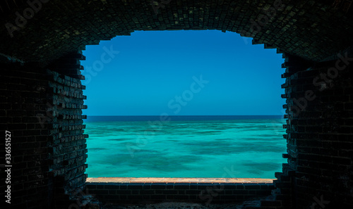 Aqua Waters Through Brick Wall Window