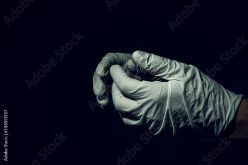 Closeup shot of a professional medical employee wearing surgical gloves