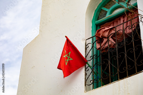 Red morroco Flag in a village photo