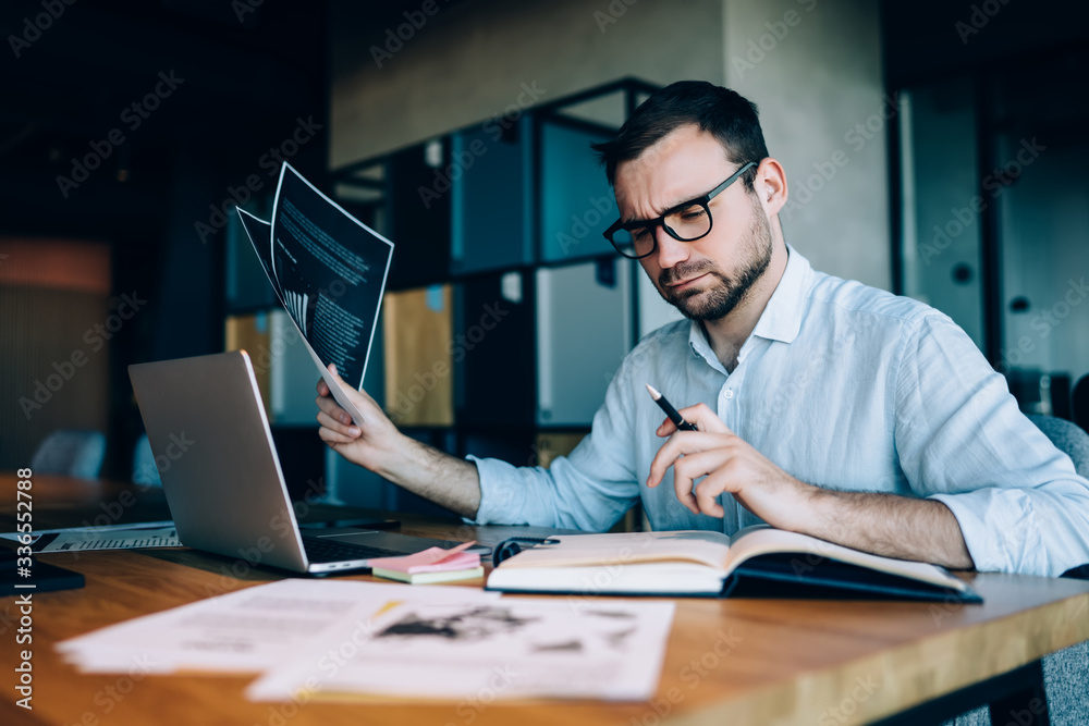 Focused businessman creating project in office Focused businessman creating project in office