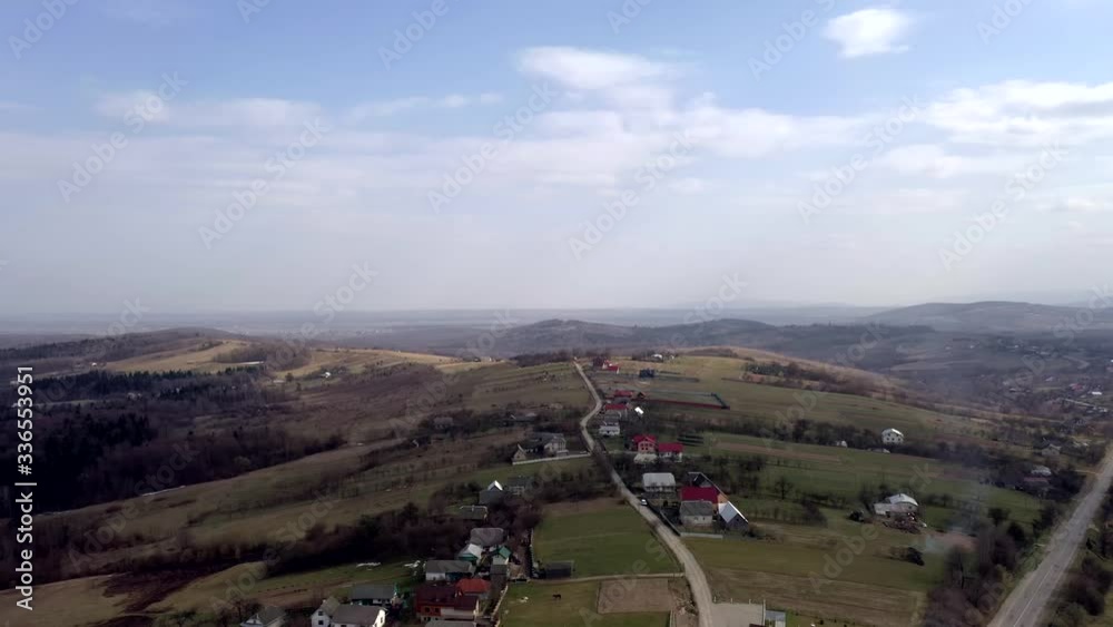 Countryside road, surrounded by lush green nature - Top down aerial image