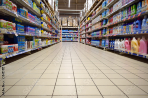 Blurred abstract background of shelf in supermarket bottom view. Department with shelves. Household chemicals in a hypermarket without people.