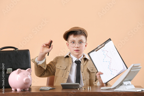 Little accountant at table ...