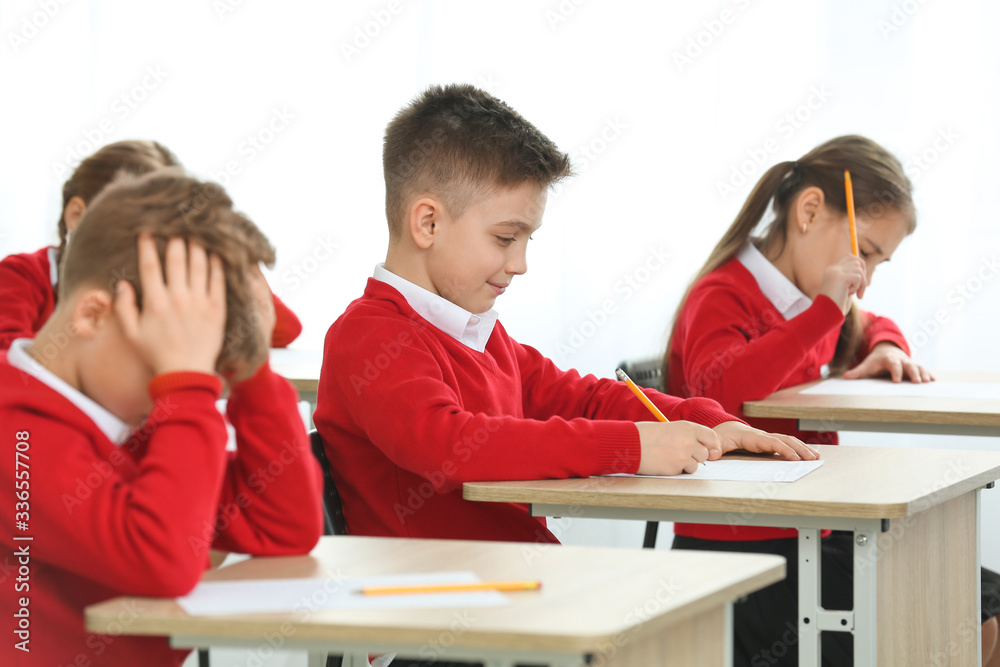 Pupils passing exam at school Pupils passing exam at school