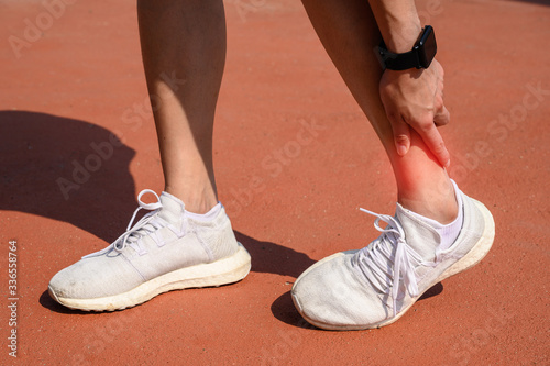 Cropped shot of woman runner suffering from ankle pain. Ankle pain may be caused by an injury  like a sprain  or by a medical condition  such as arthritis.