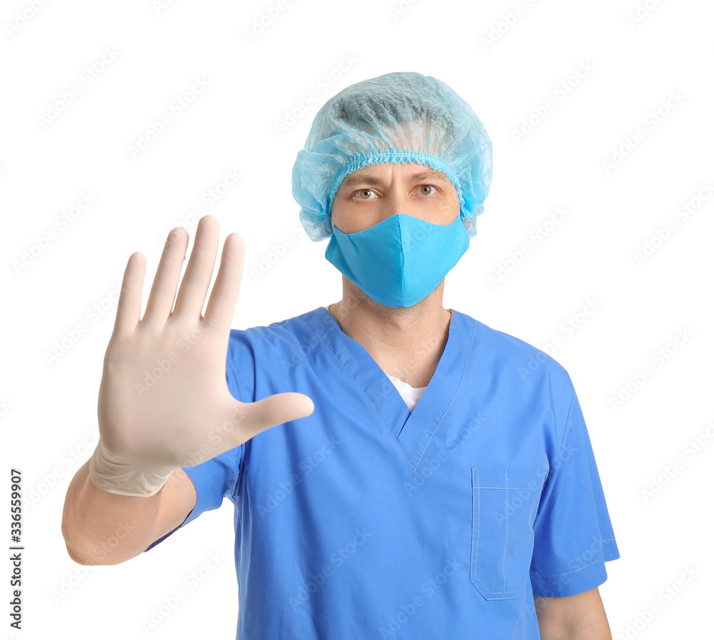 Doctor in protective medical mask showing STOP gesture on white background Doctor in protective medical mask showing STOP gesture on white background