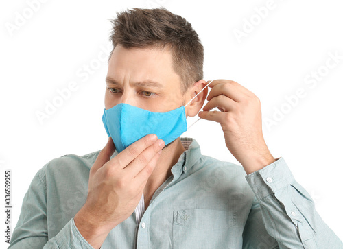 Man in protective medical mask on white background photo