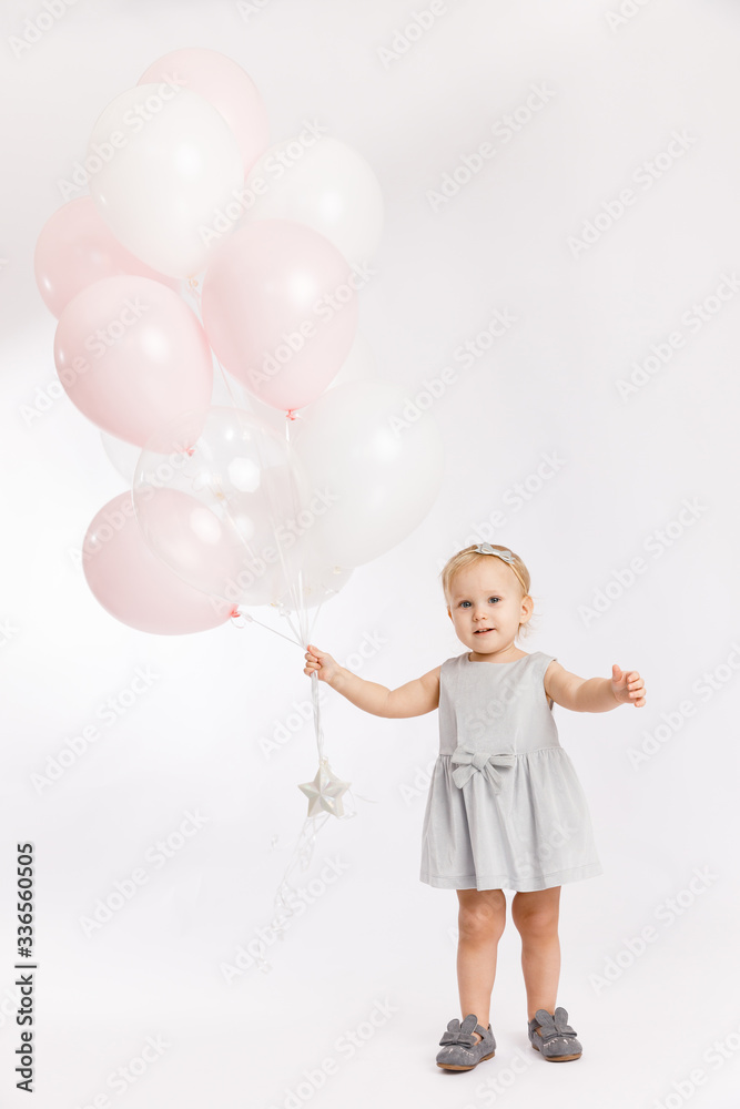 Little cute girl hold menu pink and white balloons enjoy festive birthday event wear grey pastel summer dress rabbit-footwear isolated on a white background. Little cute girl hold menu pink and white balloons enjoy festive birthday event wear grey pastel summer dress rabbit-footwear isolated on a white background.
