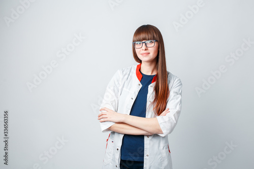 Smiling happy doctor pointing on blue background photo