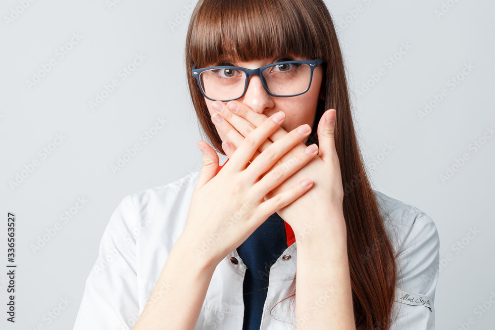 Smiling happy doctor pointing on blue background