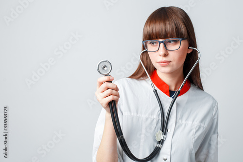 Smiling happy doctor pointing on blue background photo