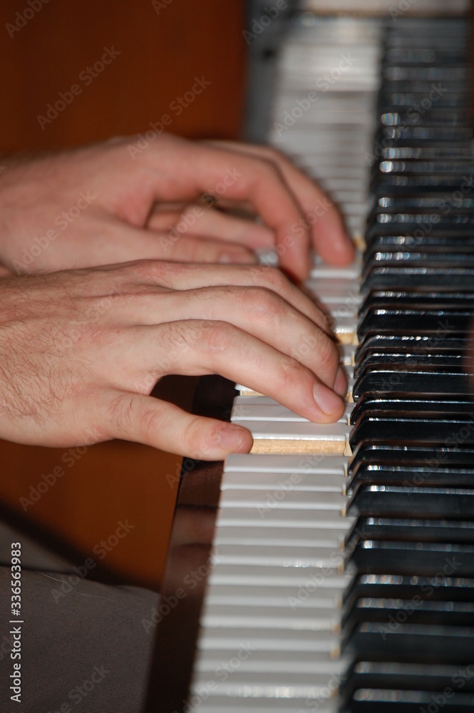 Fototapeta premium hands of a man playing piano