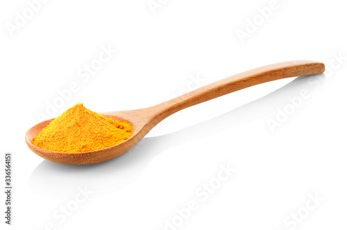 yellow turmeric in wooden spoon on white background