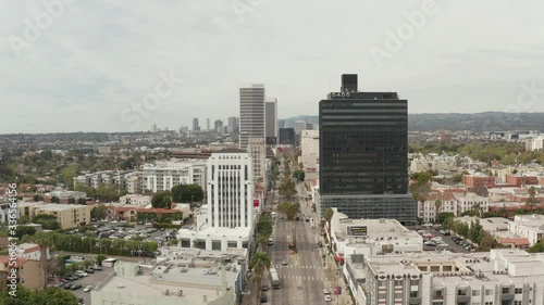 AERIAL: Flight over Wilshire Boulevard close to Street and Buildings with Car Traffic in Los Angeles, California on Overcast Day  photo