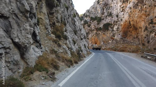 Driving a car on a mountain road on a summer day. Crete island, Greece. Car rental and travel concept. photo