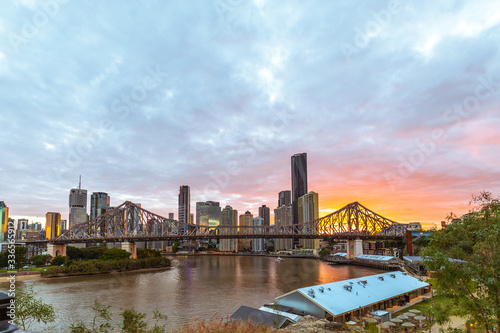 Brisbane skyline with scraper with Story bridge at sunset pastel red golden and purple colors