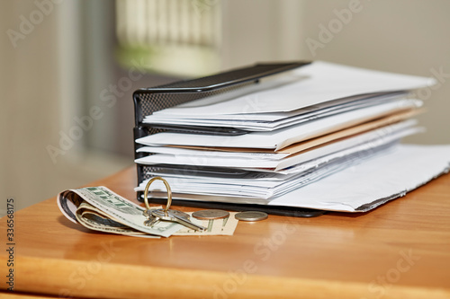 Paper Envelopes with Keys and Money on a Desk