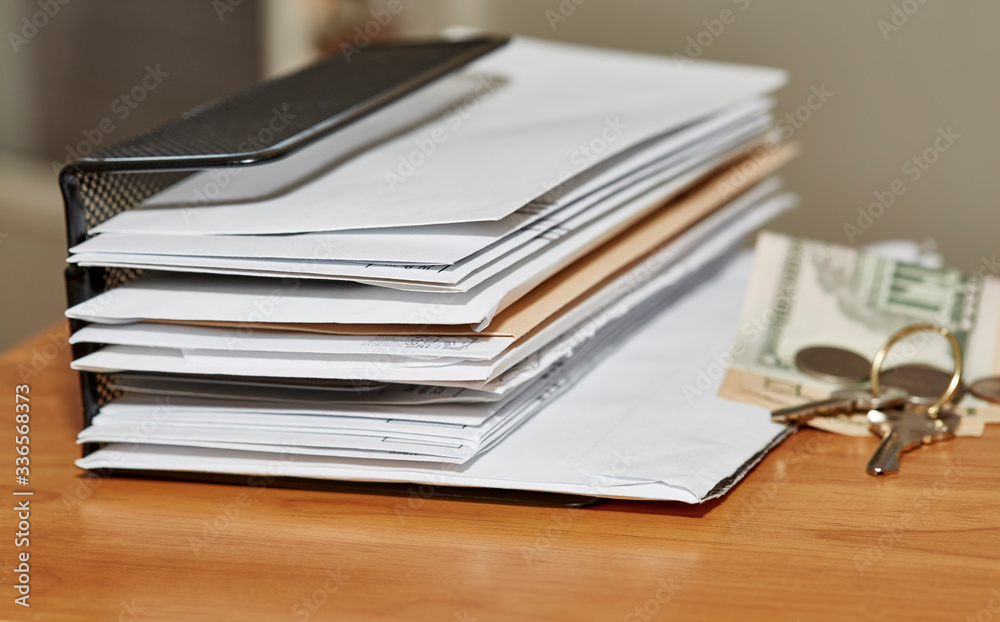 Paper Envelopes with Keys and Money on a Desk Paper Envelopes with Keys and Money on a Desk