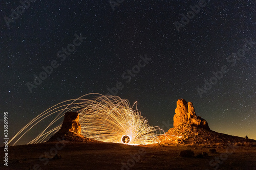 Obraz na płótnie sparks flying in the desert night between tufa formations at Trona Pinnacles, Ca