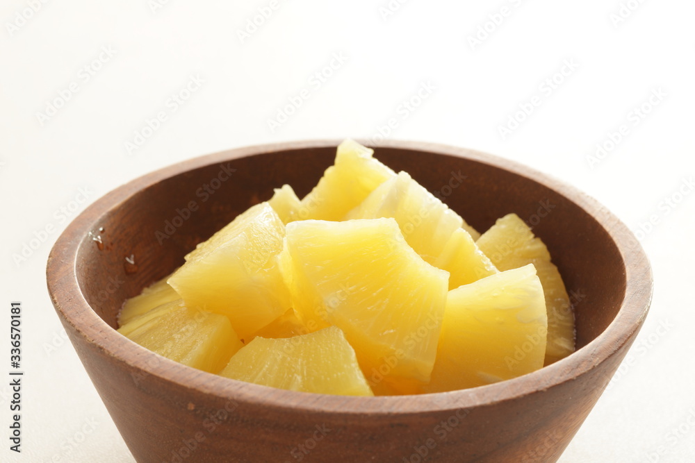 Canned food, pineapple in wooden bowl with copy space Canned food, pineapple in wooden bowl with copy space