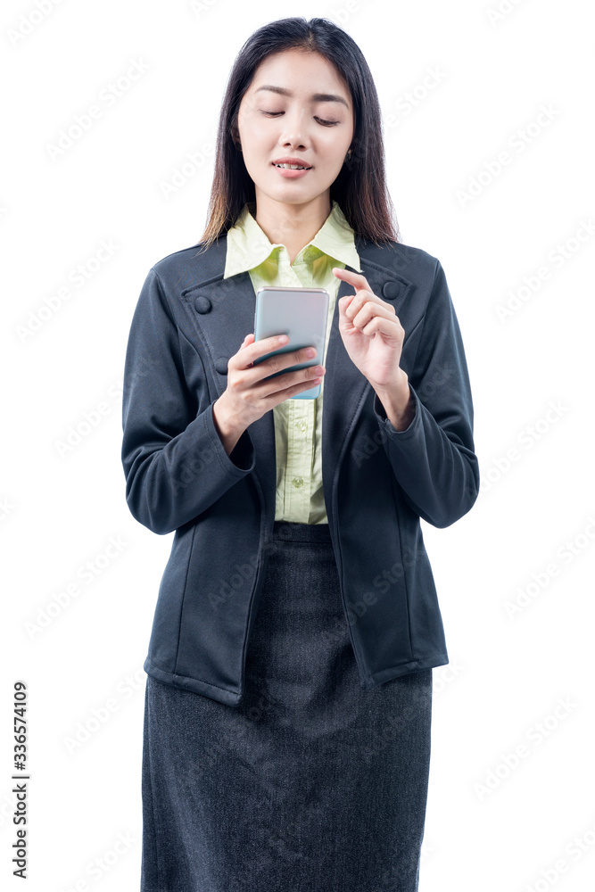 Asian businesswoman standing while using mobile phone Asian businesswoman standing while using mobile phone
