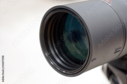 Closeup a black binoculars or a telescope lens     