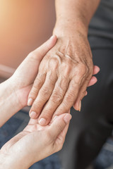 Parkinson disease patient, Alzheimer elderly senior, Arthritis person's hand in support of nursing family caregiver care for disability awareness day, National care givers month, ageing society