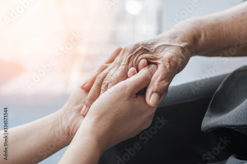 Parkinson disease patient, Alzheimer elderly senior, Arthritis person hand in support of nursing family caregiver care for disability awareness day, National care givers month, ageing society concept